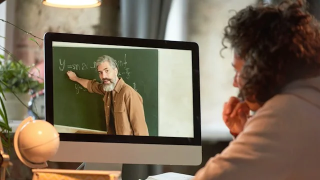 Woman watching an online lecture on a computer screen, the kind of course video covered by the Simplilearn video privacy settlement.