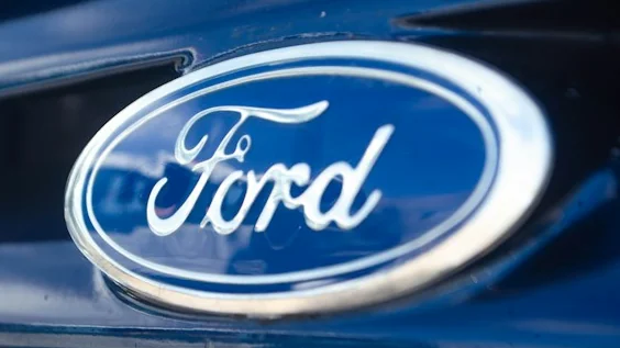 Ford oval badge on a dark blue vehicle, the maker of the 2023-2024 Transit Trail vans in the Ford Transit Trail settlement.