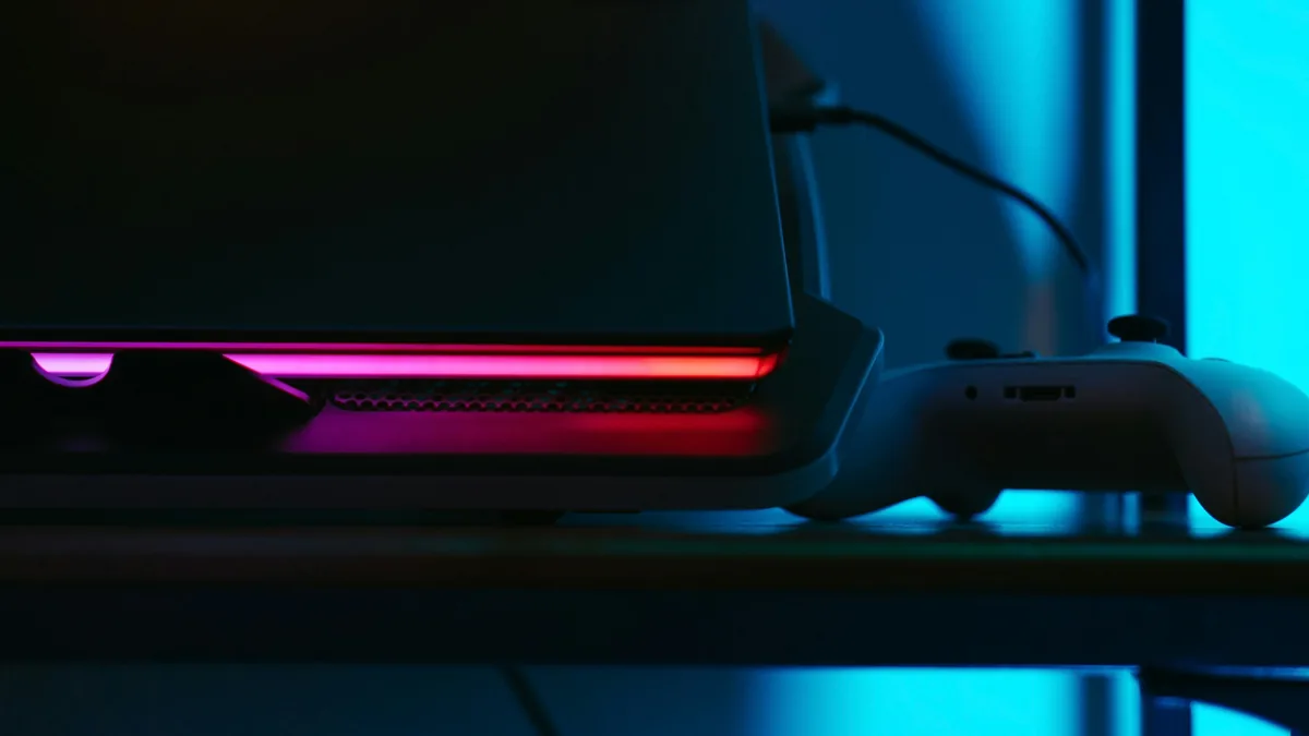 Game controller beside a monitor in neon light – GameStop class action