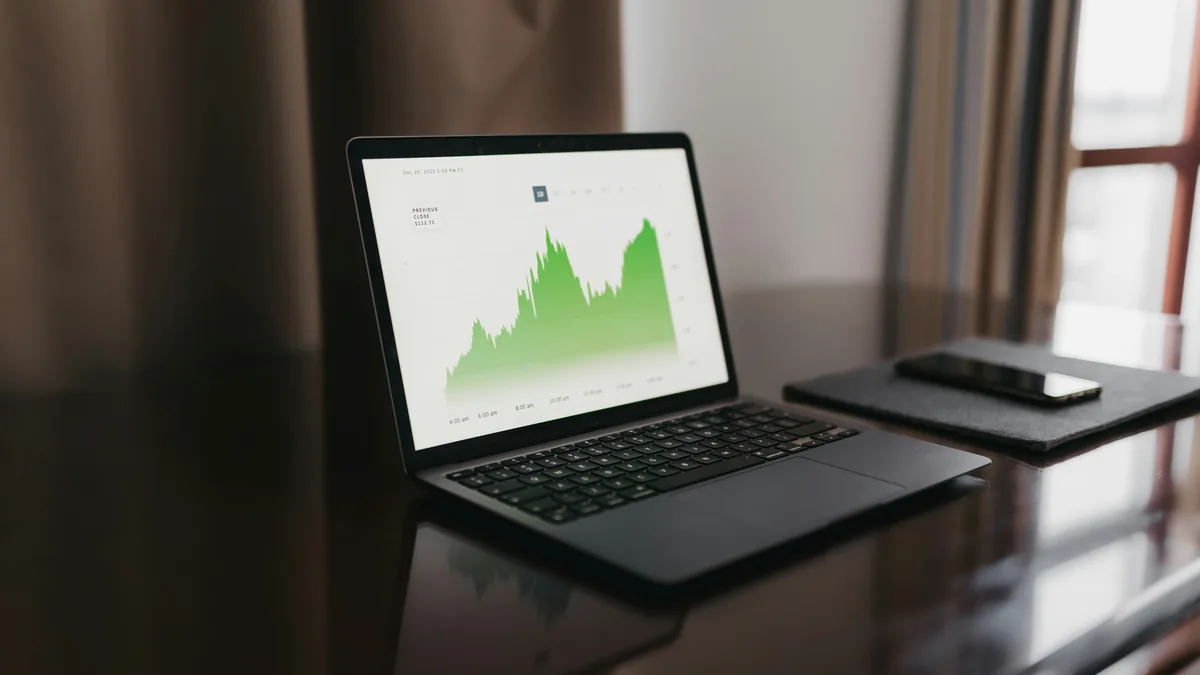 Laptop showing an investment chart on a desk – Fidelity Investments data breach class action