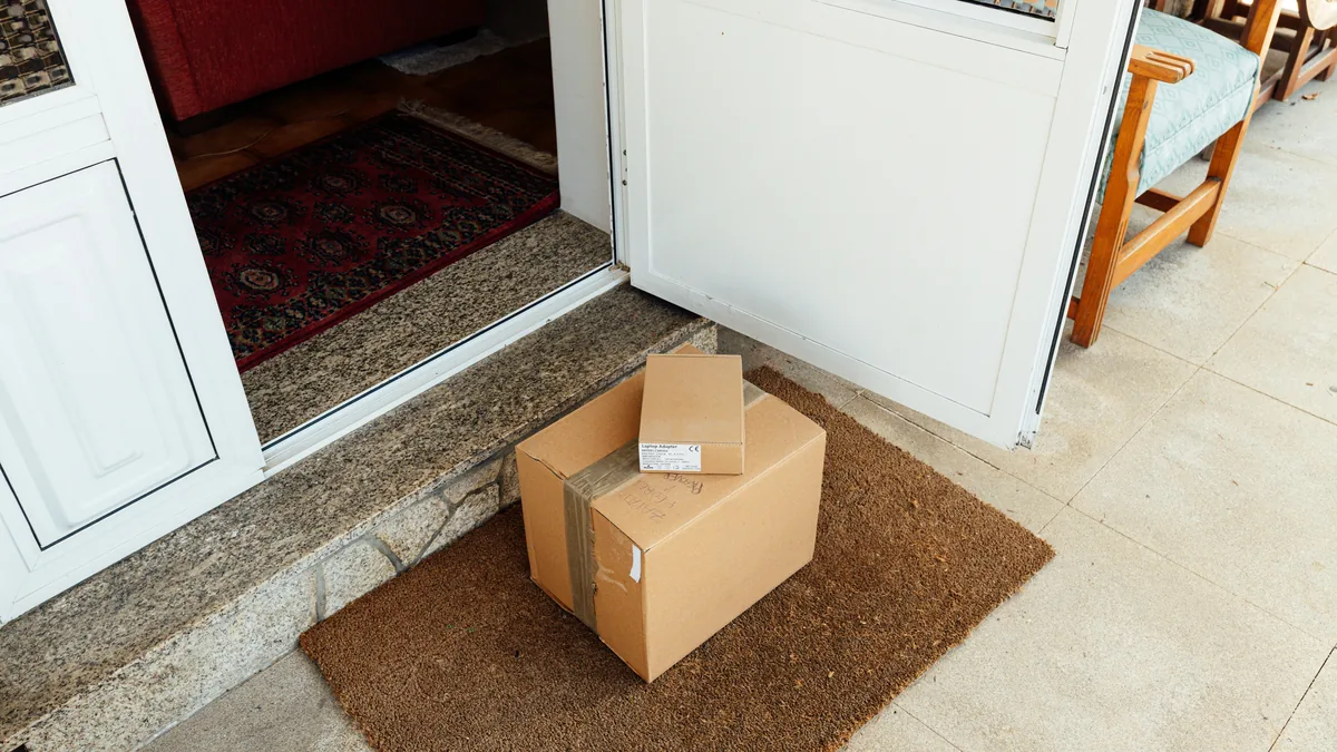 Cardboard parcels left on a doormat at a front door – Amazon Prime class action