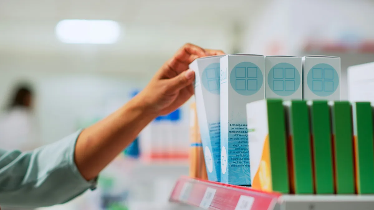 Hand taking a medicine box from a pharmacy shelf – CVS digital privacy class action