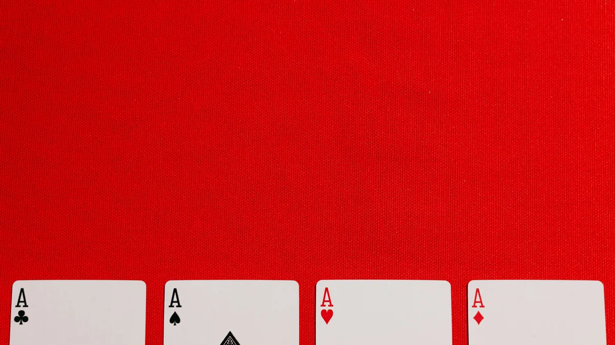 Four aces laid out on a red table – Papaya Gaming Solitaire Cash class action