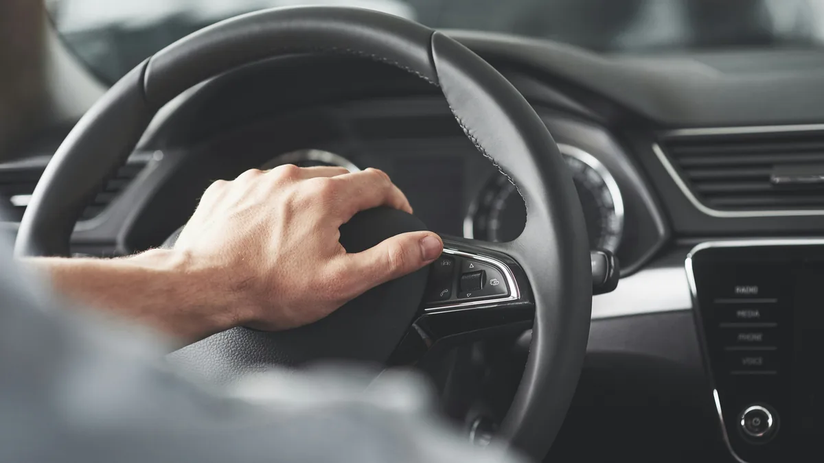 Driver's hand on a car steering wheel – Hyundai airbag control unit class action