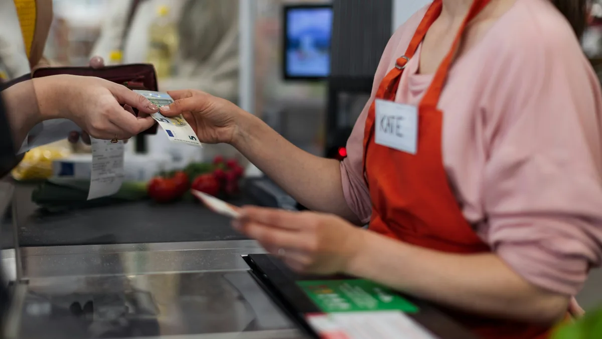 Shopper paying a cashier at a store checkout – Dollar General overcharging class action