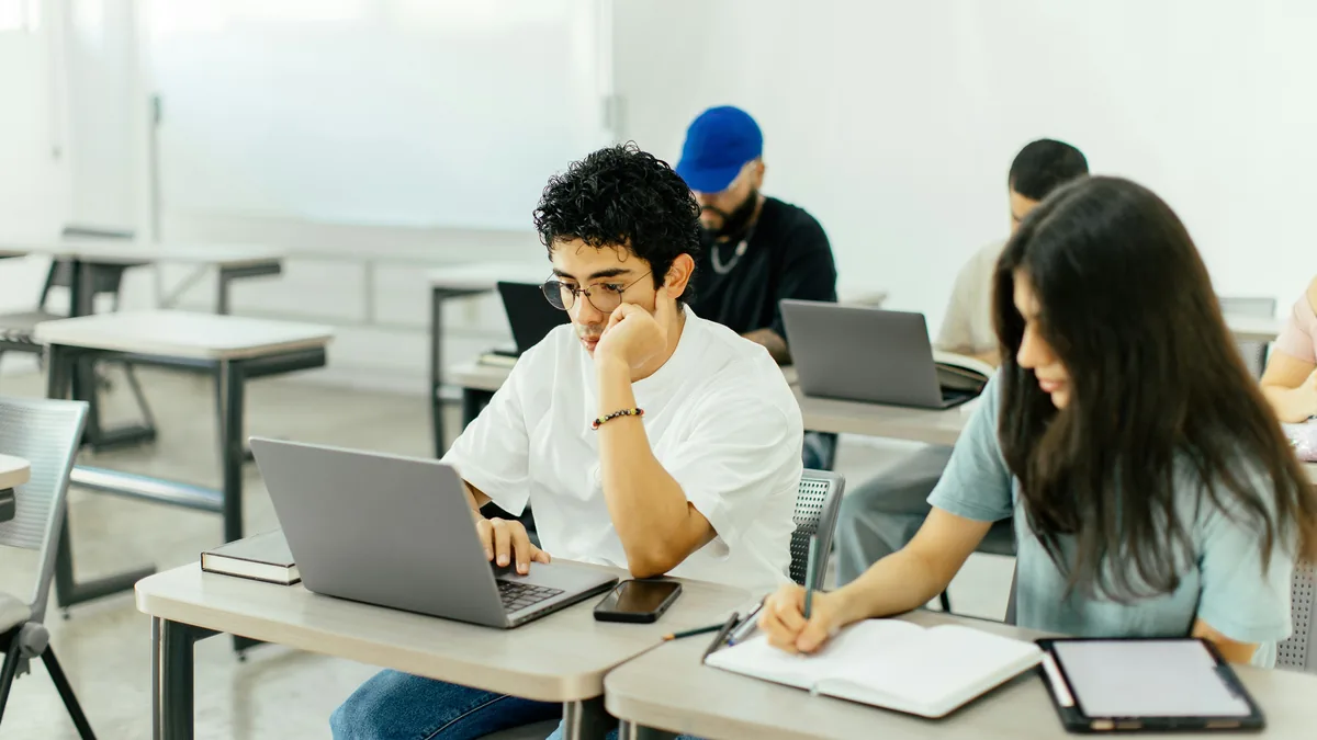 Students working on laptops in a classroom – Google class action