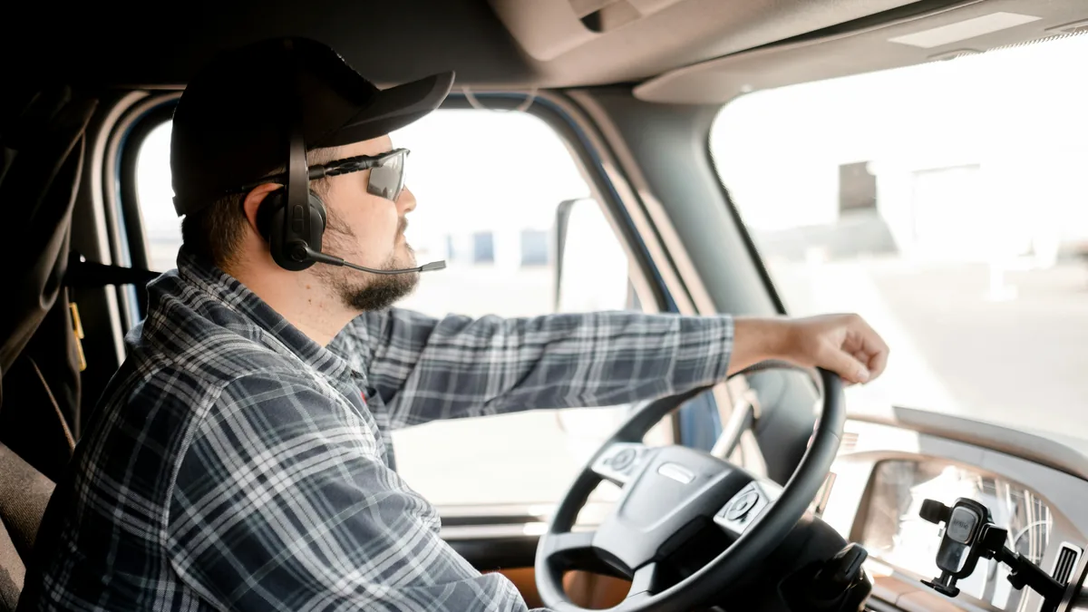 Truck driver at the wheel of a semi truck cab – Samsara dash cam biometric privacy class action