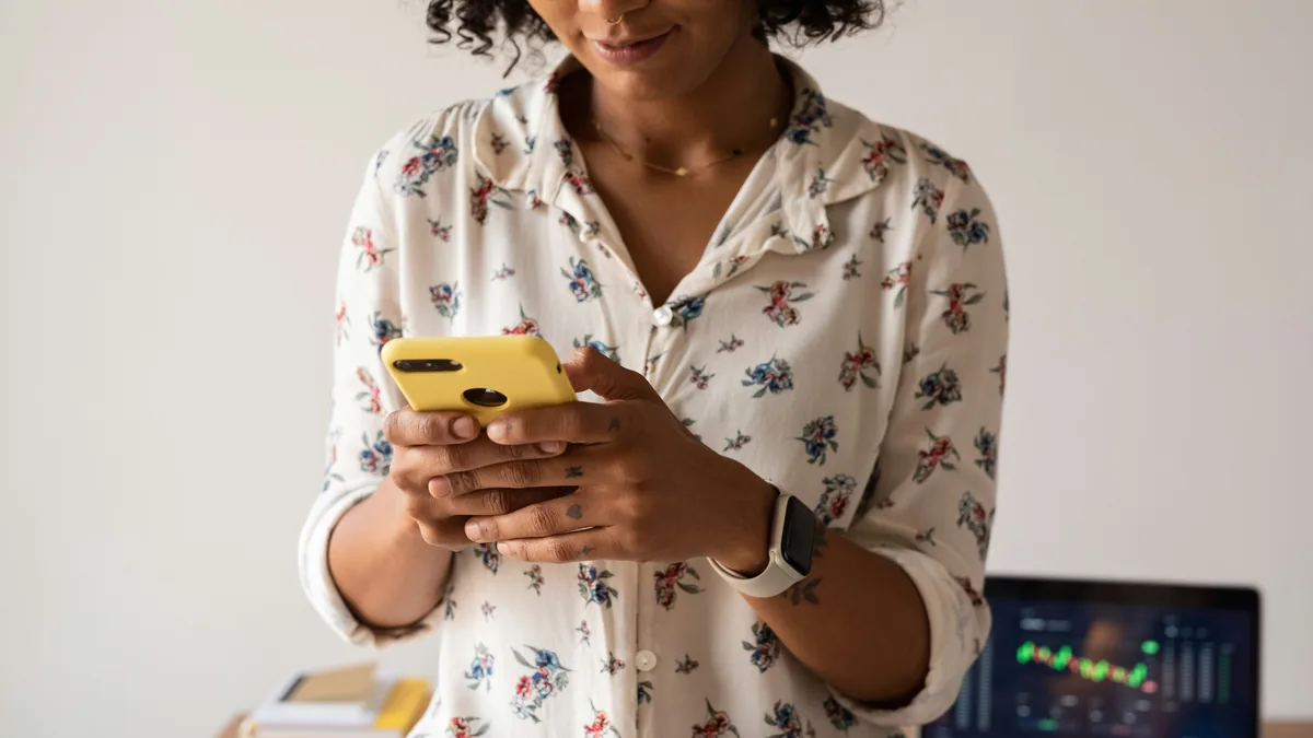 Woman in a floral shirt using a smartphone – Flo period tracker data privacy class action